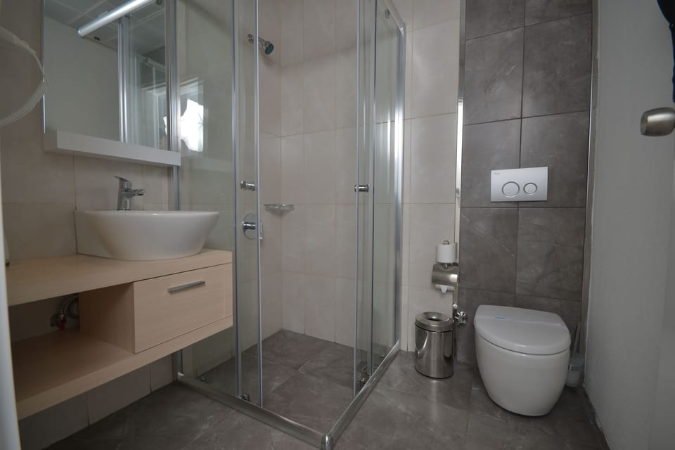 Shower, designer toiletries, hair dryer, slippers