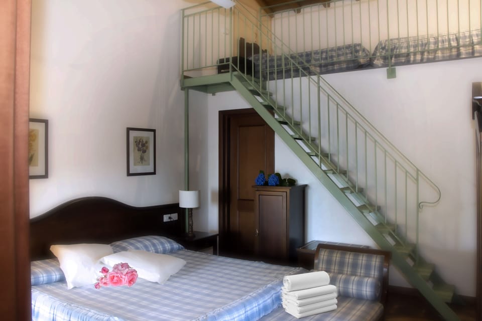 Quadruple Room | Minibar, in-room safe, desk, iron/ironing board