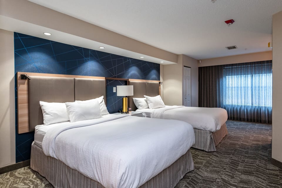 Premium bedding, desk, laptop workspace, blackout drapes