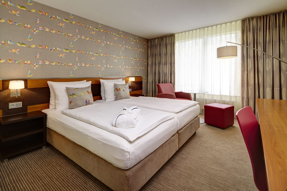 Hypo-allergenic bedding, desk, laptop workspace, blackout drapes