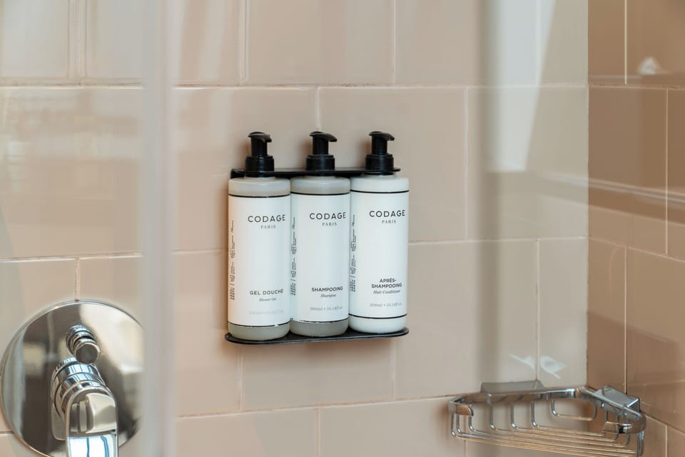 Chambre Parisienne | Bathroom | Free toiletries, hair dryer, bathrobes, slippers