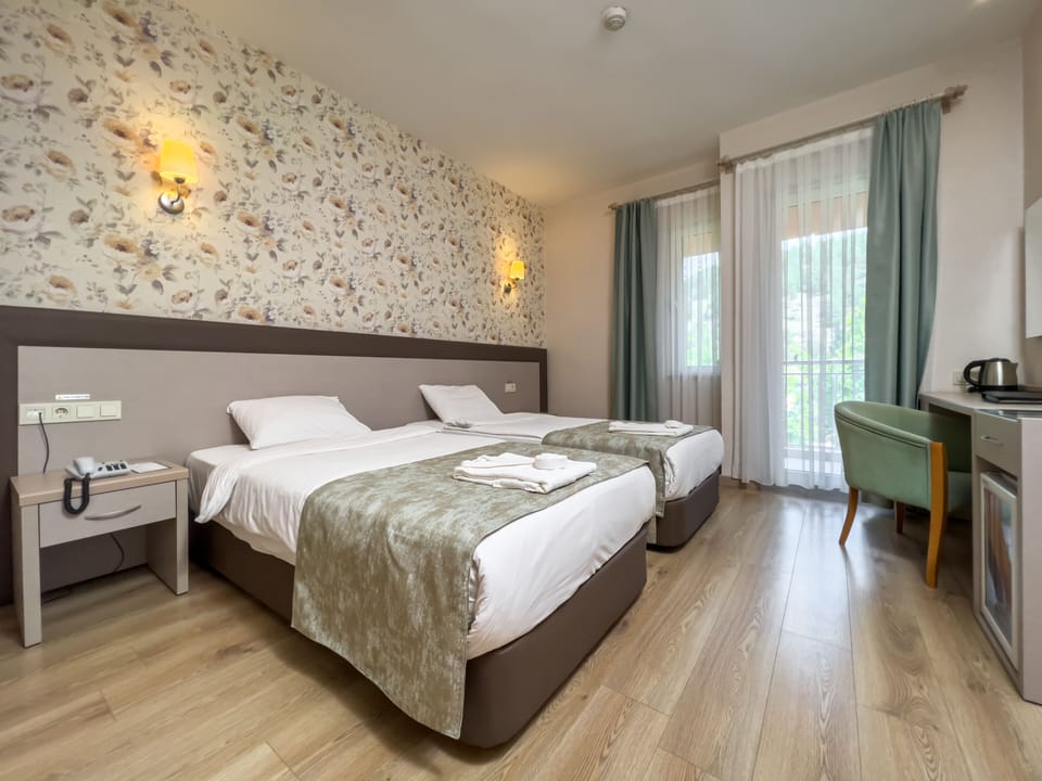 Standard Triple Room | Minibar, in-room safe, desk, soundproofing