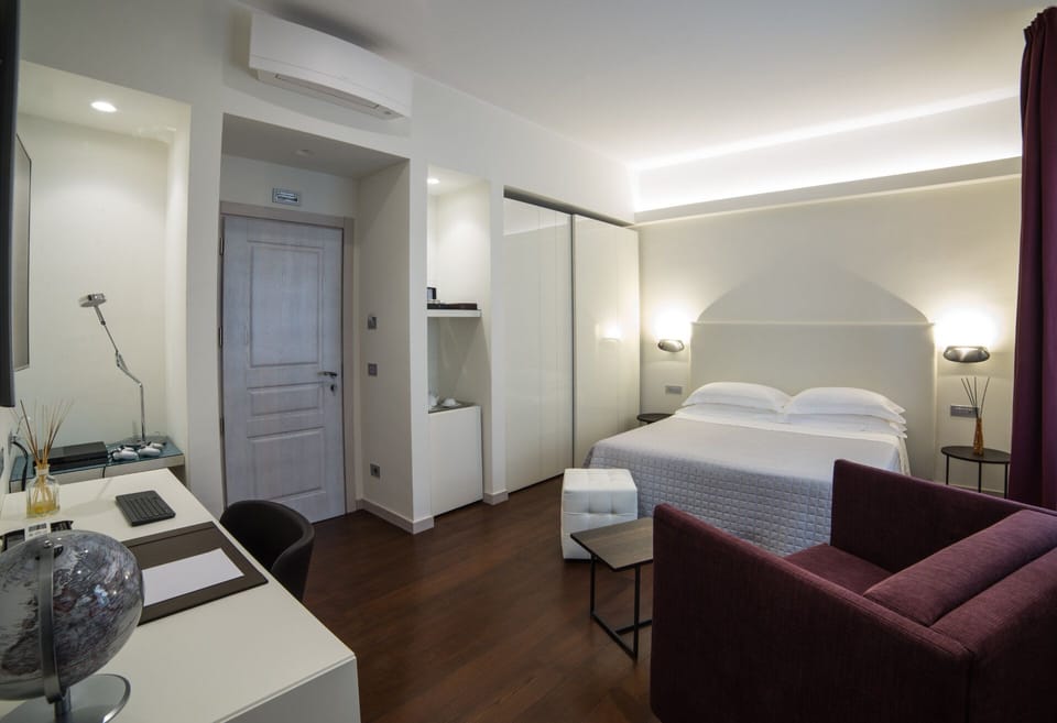 Deluxe Double Room, Partial Sea View | Minibar, in-room safe, desk, soundproofing