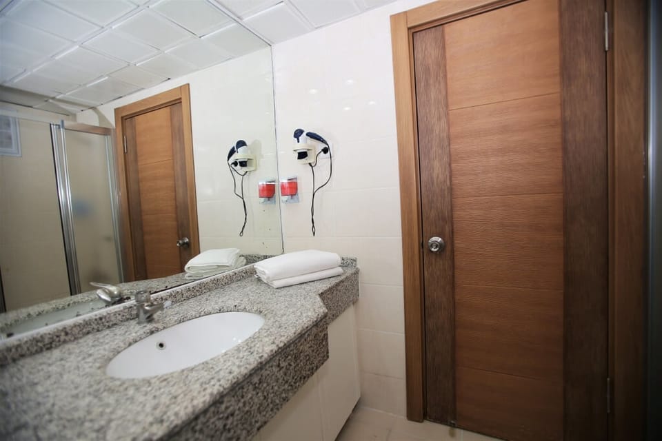 Shower, hair dryer, slippers, towels