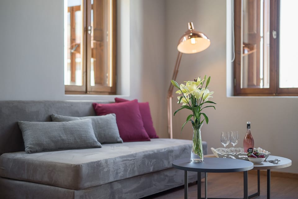 Deluxe Quadruple Room, Multiple Beds | Living area | Flat-screen TV