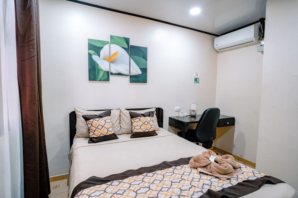 Premium bedding, desk, laptop workspace, blackout drapes