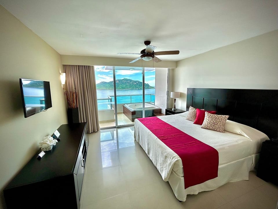 Deluxe Suite, Hot Tub, Sea View | In-room safe, laptop workspace, iron/ironing board, bed sheets