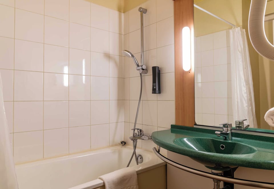 Bathtub, eco-friendly toiletries, hair dryer, towels