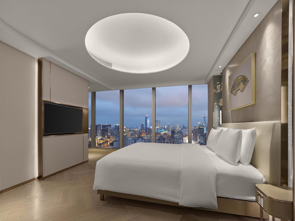 Premium Suite | Minibar, in-room safe, desk, blackout drapes