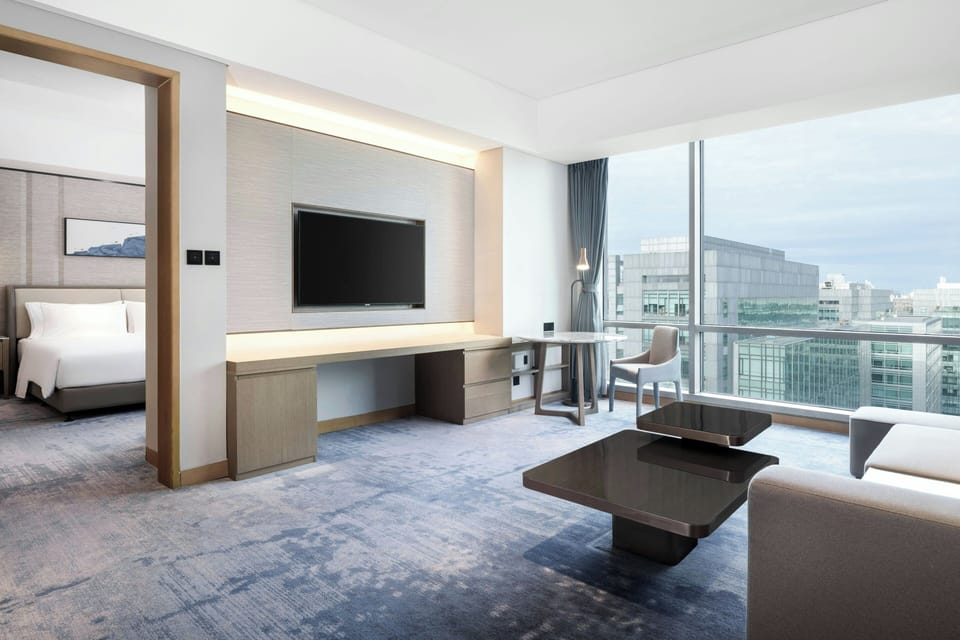 Deluxe Suite, 1 King Bed | Living room | 55-inch LCD TV with cable channels, TV, pay movies