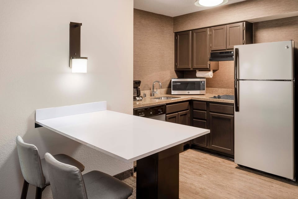 Premium bedding, desk, laptop workspace, blackout drapes