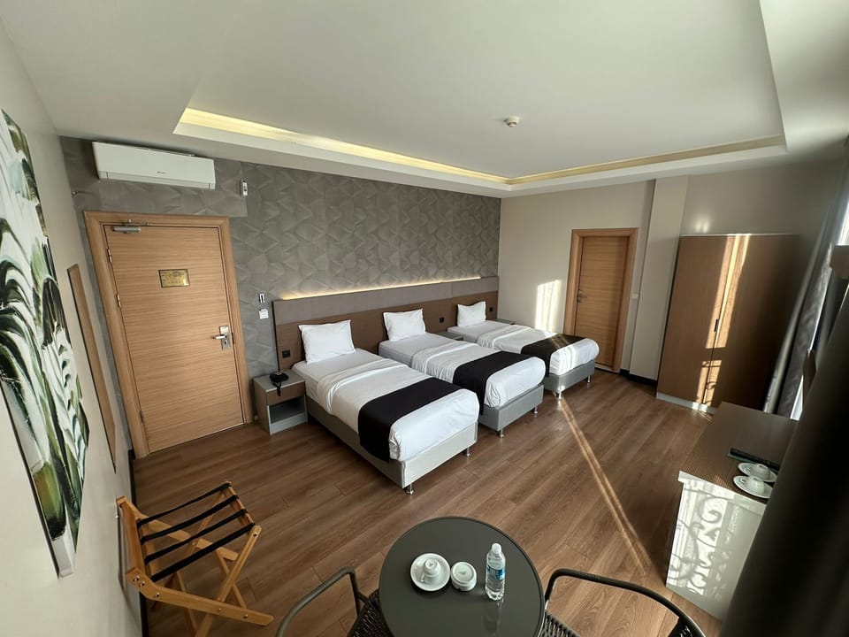 Deluxe Triple Room | Minibar, in-room safe, laptop workspace, soundproofing