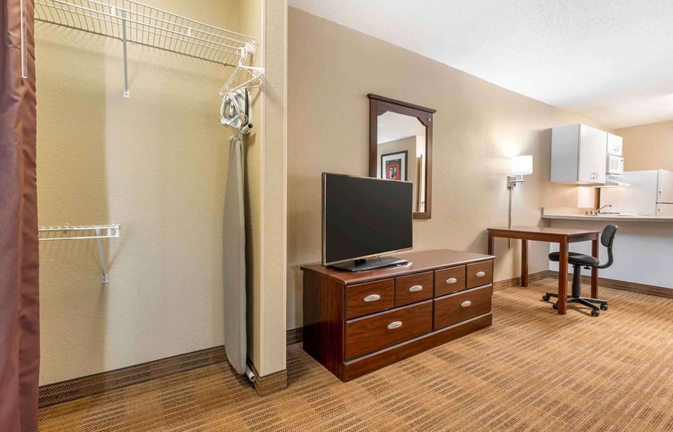 Desk, laptop workspace, blackout drapes, iron/ironing board