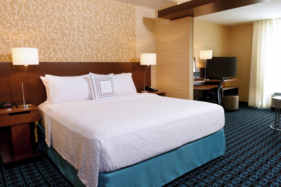 Premium bedding, desk, laptop workspace, blackout drapes