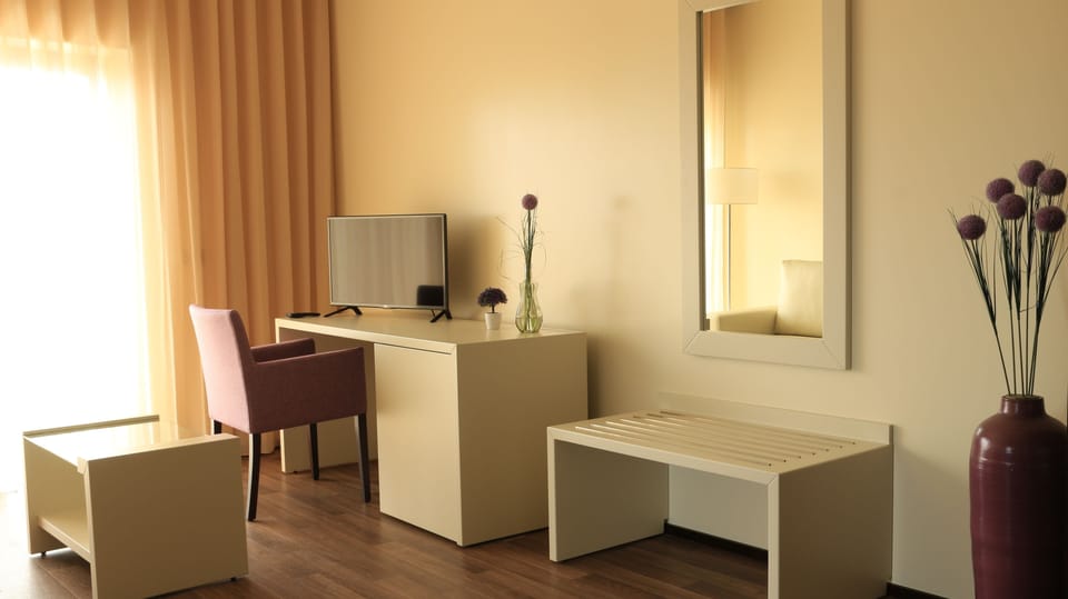 Suite, City View | Minibar, in-room safe, desk, blackout drapes