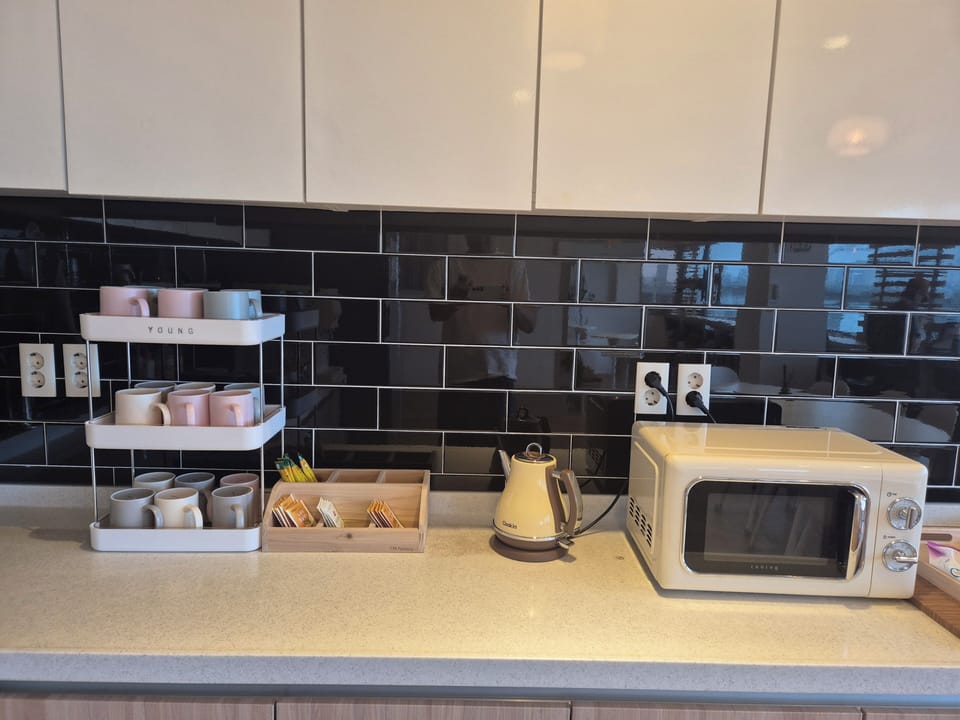 Full-size fridge, microwave, coffee grinder, cookware/dishes/utensils
