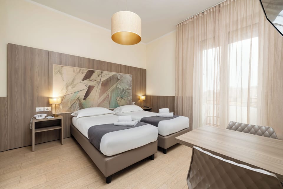 Twin Room | Minibar, in-room safe, desk, soundproofing
