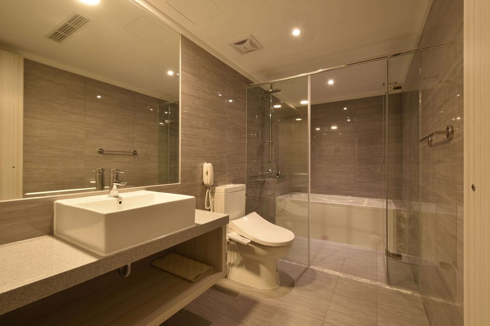 Separate tub and shower, hair dryer, slippers, towels