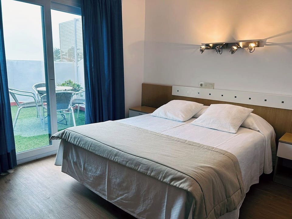 Deluxe Quadruple Room | In-room safe, desk, laptop workspace, blackout drapes