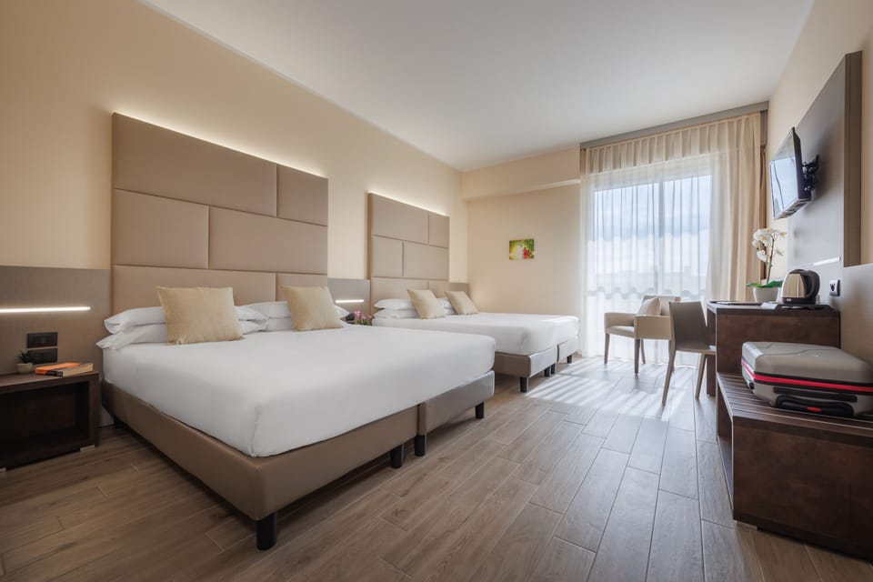 Family Quadruple Room | Minibar, in-room safe, desk, blackout drapes