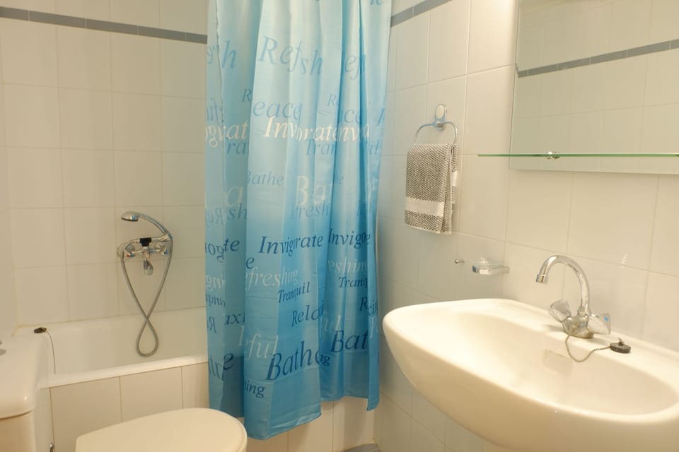 Apartment, 2 Bedrooms | Bathroom | Bathtub, hair dryer, slippers, towels