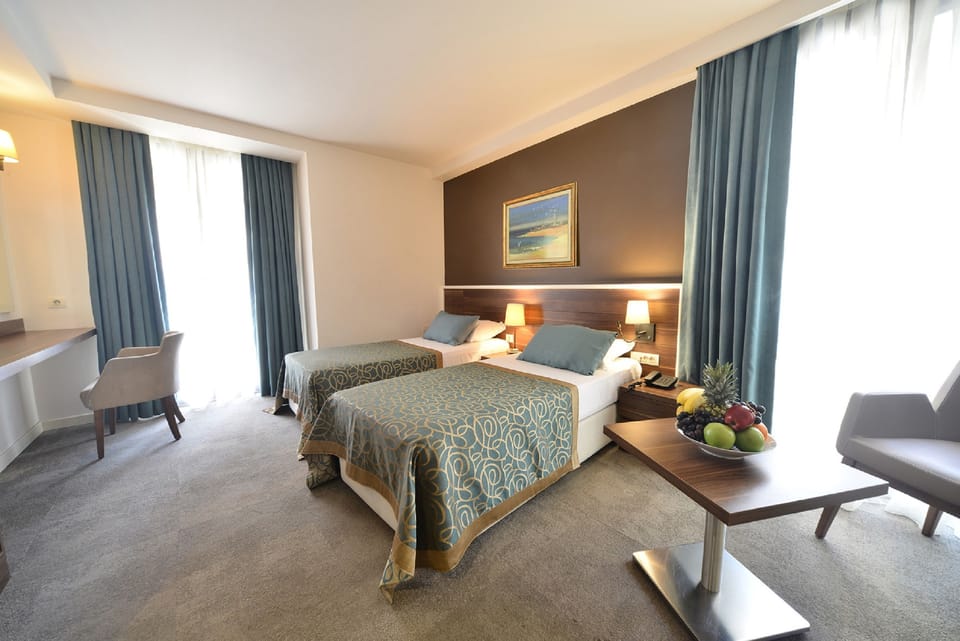 Deluxe Triple Room | Free minibar items, in-room safe, desk, iron/ironing board
