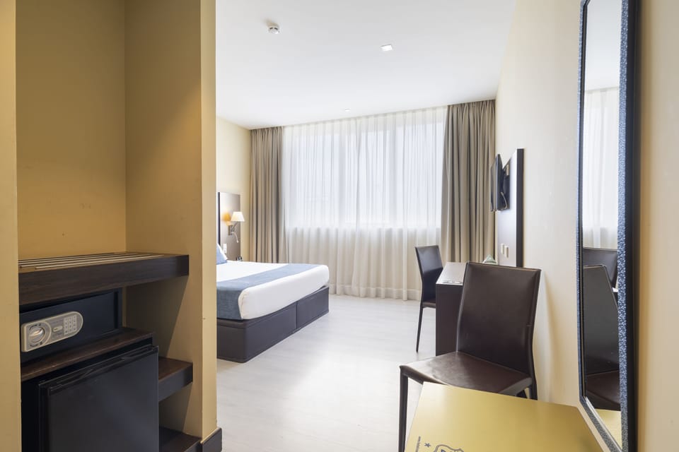 Standard Double Room | Minibar, in-room safe, desk, blackout drapes