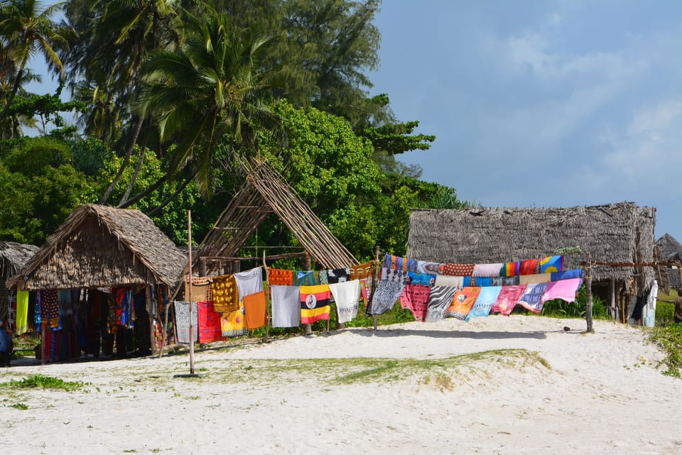 On the beach, white sand, beach umbrellas, beach towels