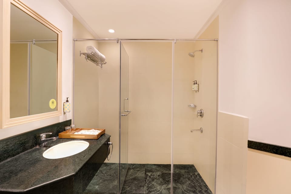 Studio Room | Bathroom | Rainfall showerhead, free toiletries, hair dryer, bathrobes