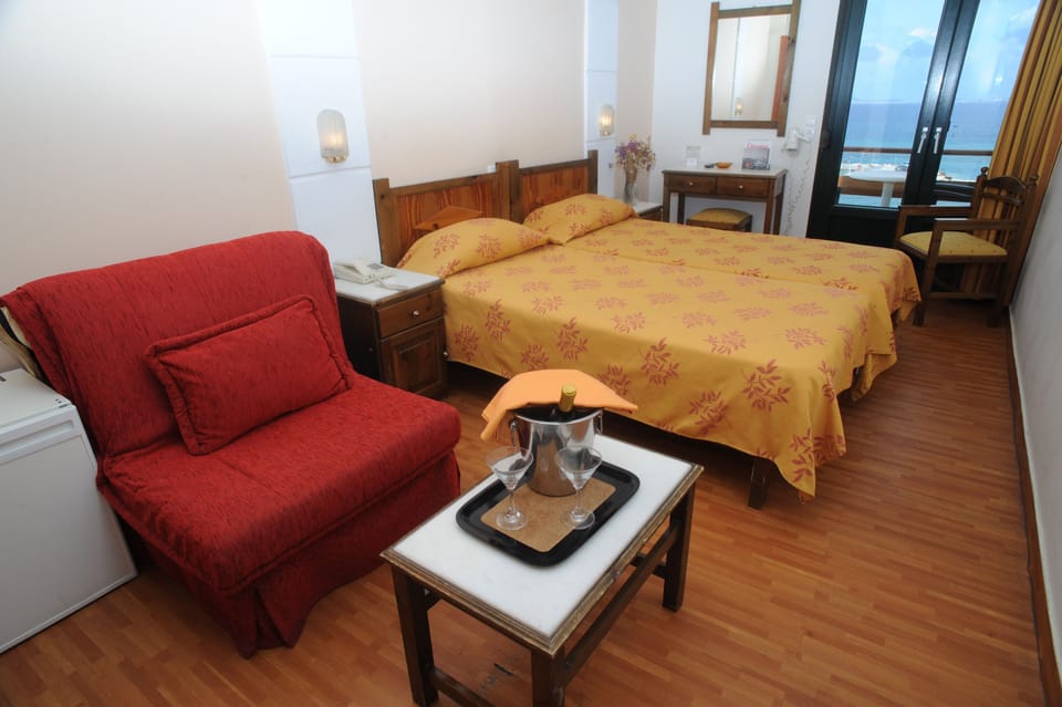 Standard Triple Room (Port View) | Living area | 32-inch plasma TV with satellite channels, TV