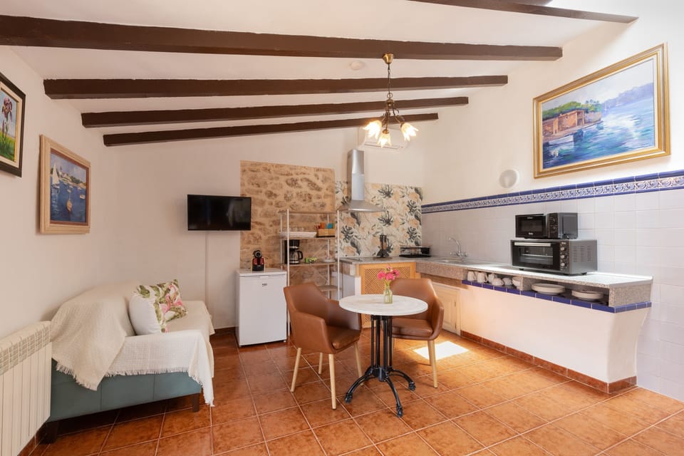 Llebeig studio with terrace and pool and garden view | Living area | TV
