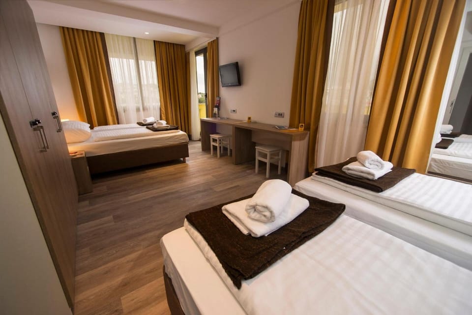 Classic Quadruple Room, Balcony | In-room safe, WiFi (free), bed sheets