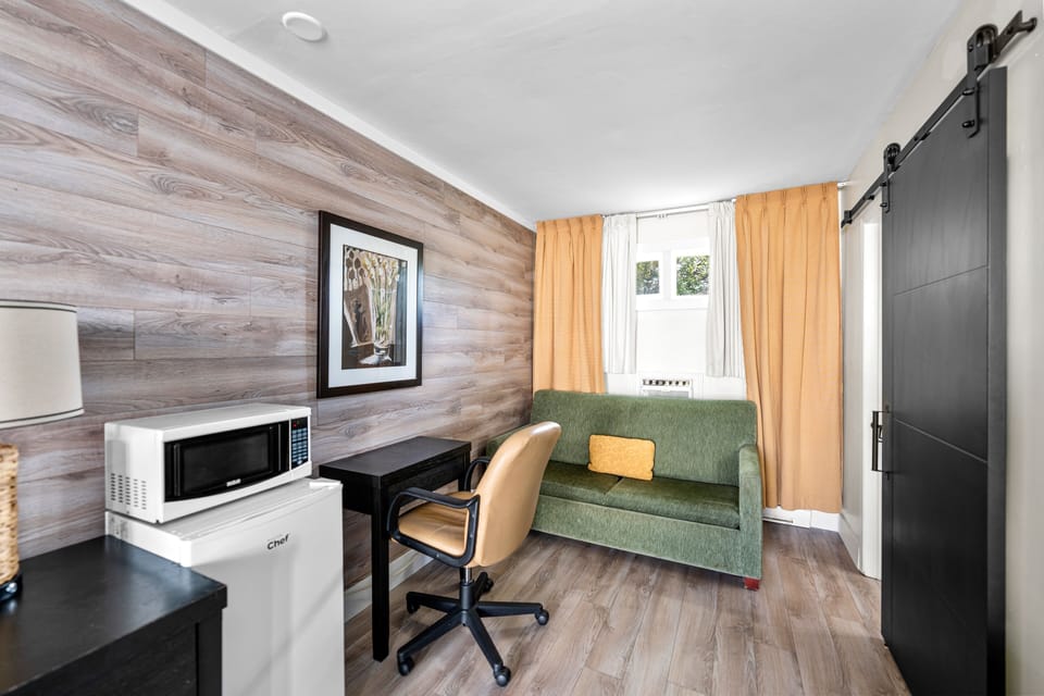 Economy Room, 2 Double Beds | Living area | Flat-screen TV