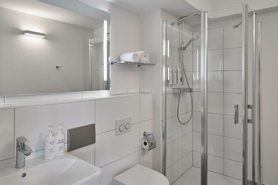 Shower, eco-friendly toiletries, hair dryer, towels