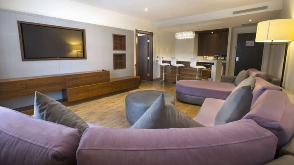 Junior Suite, 1 King Bed, Microwave, Tower (Deluxe Junior) | Living area | 48-inch LED TV with cable channels, TV, iPod dock