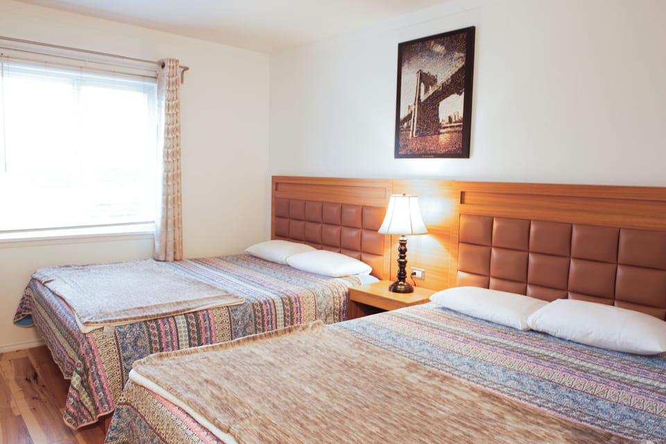 Basic Room, 2 Queen Beds | Desk, cribs (free), WiFi (free), bed sheets