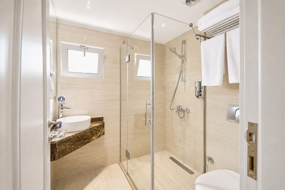 Shower, designer toiletries, hair dryer, bathrobes