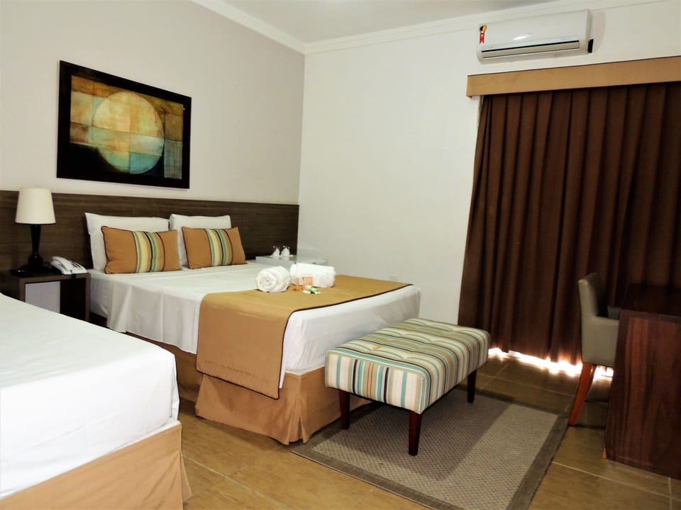 Deluxe Triple Room | Minibar, individually decorated, desk, blackout drapes