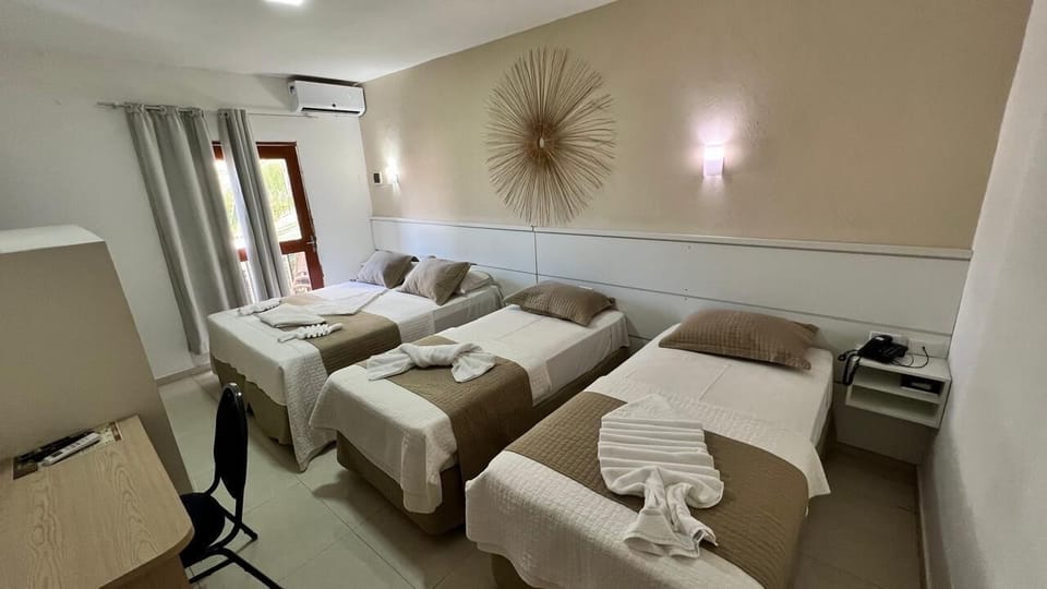 Quadruple Room, Partial Sea View | Minibar, blackout drapes, WiFi (free), bed sheets
