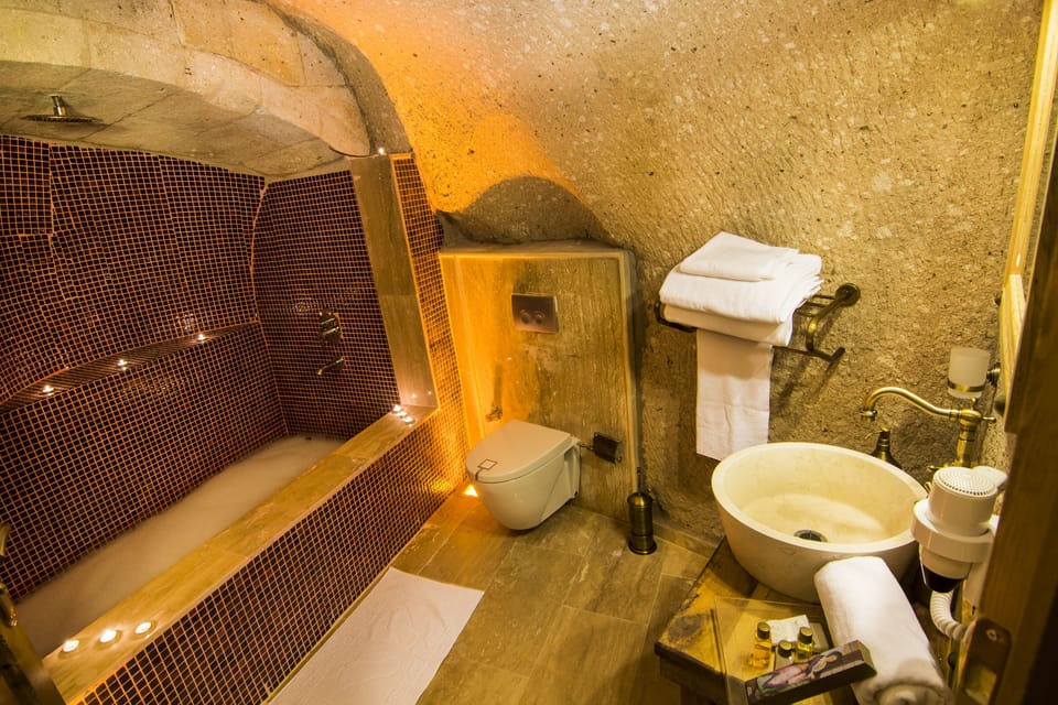Family Cave Suite | Bathroom | Designer toiletries, hair dryer, slippers, towels