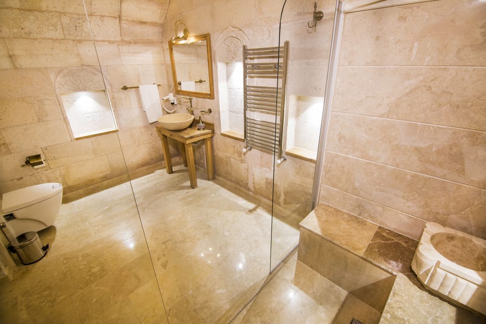 King Suite | Bathroom | Designer toiletries, hair dryer, slippers, towels