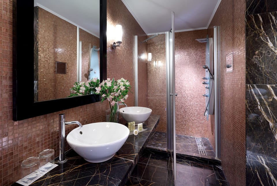 Rainfall showerhead, designer toiletries, hair dryer, slippers