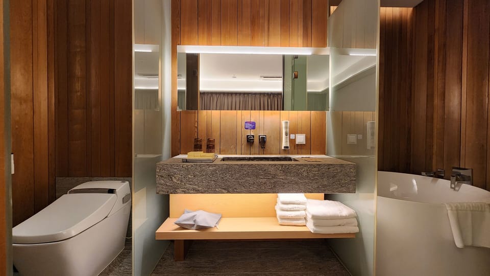Sotetsu Splaisir Suite | Bathroom | Hair dryer, slippers, bidet, towels