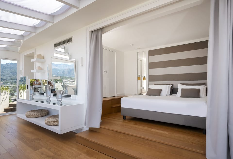 Executive Suite, Terrace, Sea View | Minibar, in-room safe, desk, blackout drapes