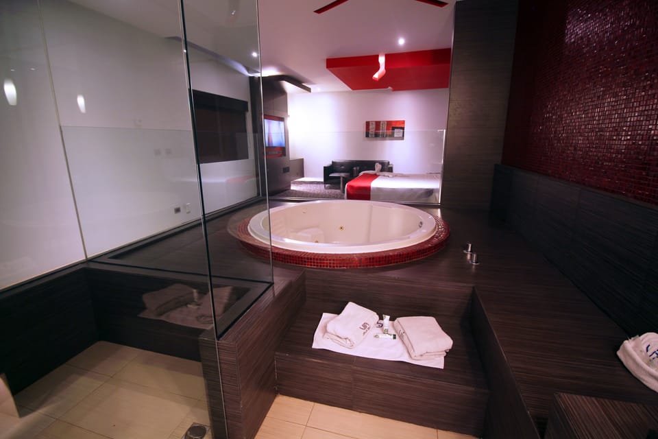 Suite, 1 King Bed, Jetted Tub | Bathroom | Shower, free toiletries, towels