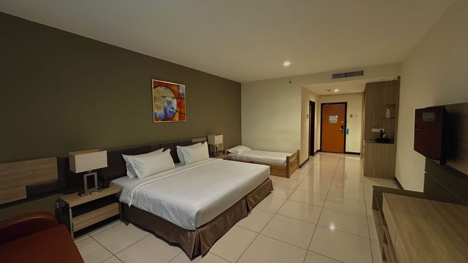 Deluxe Triple Room, Multiple Beds | In-room safe, desk, laptop workspace, blackout drapes