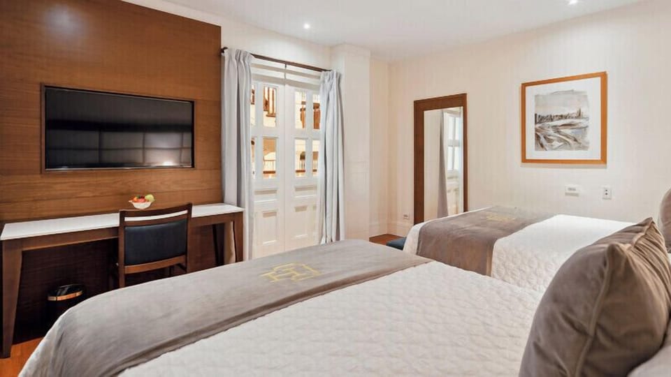 Family Room, 2 Queen Beds | Minibar, in-room safe, desk, laptop workspace