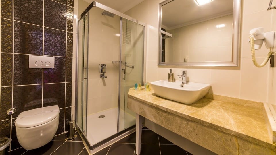 Shower, hair dryer, slippers, towels