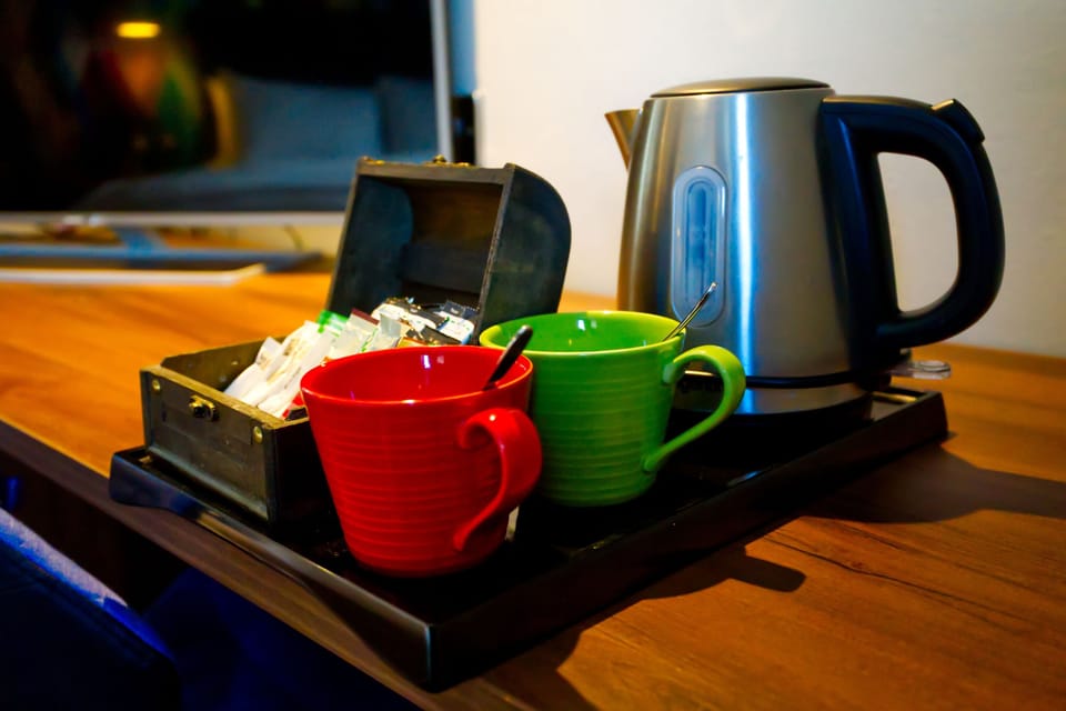 Desk, laptop workspace, blackout drapes, iron/ironing board