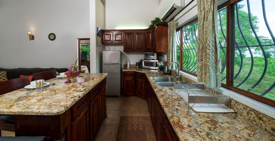Apartment, 1 King Bed | Private kitchen | Coffee/tea maker, full-size fridge, microwave, oven